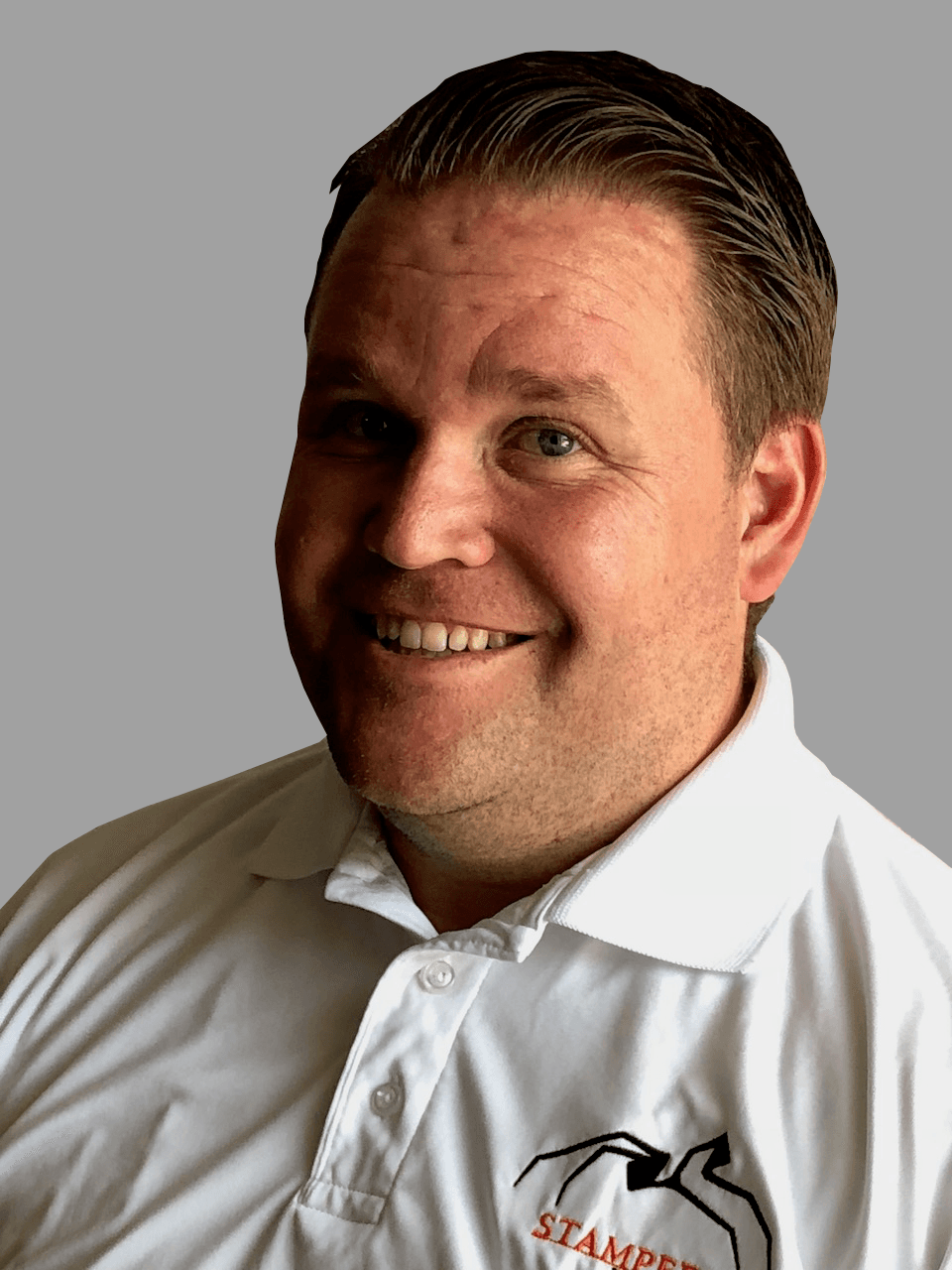 Stampede team member smiling in a branded white polo shirt.